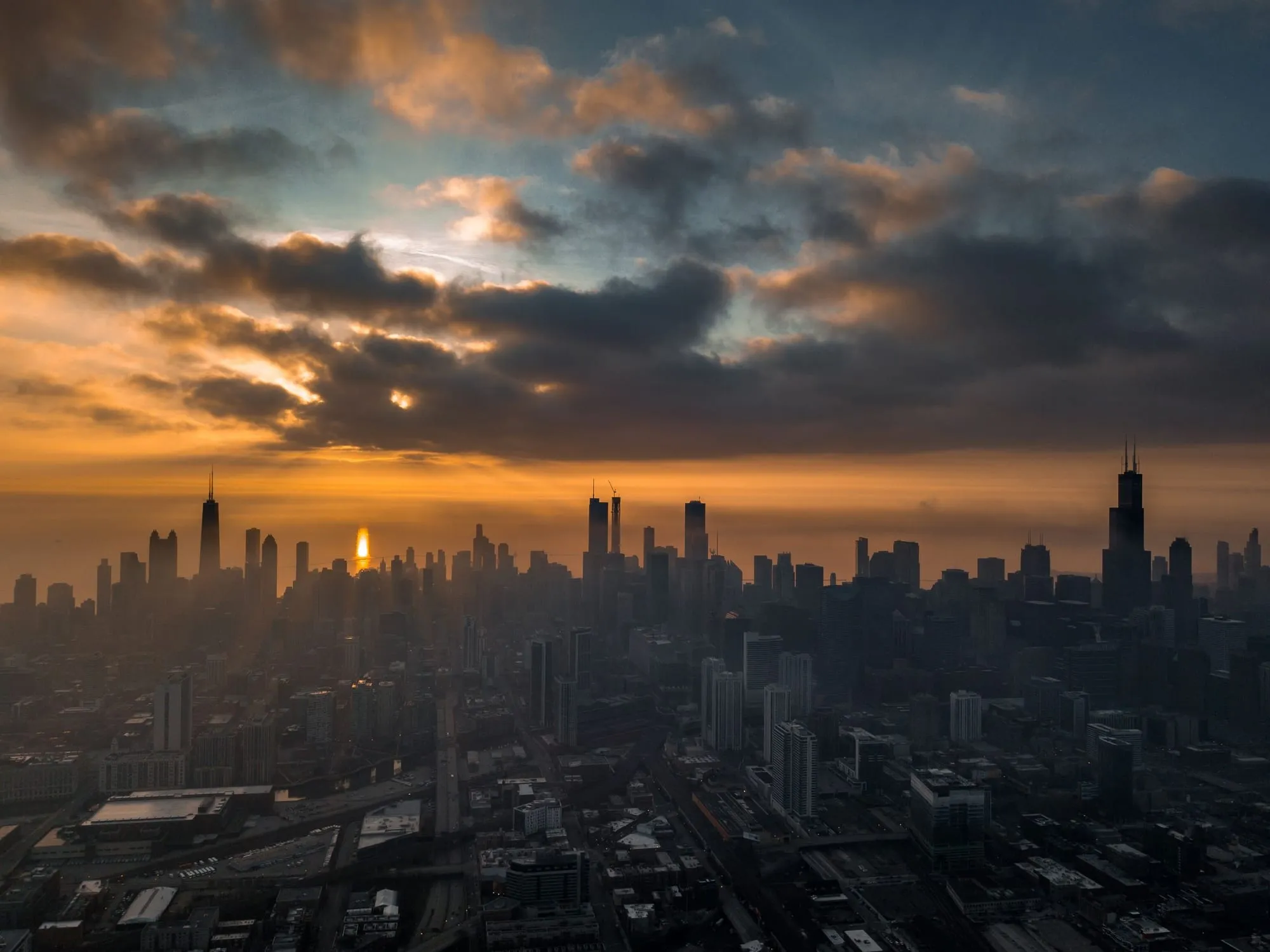 A city skyline at dusk, seen from a high floor.